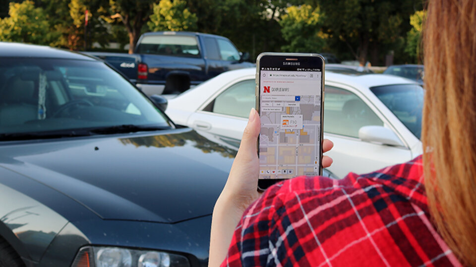 woman holding a phone with a map pulled up