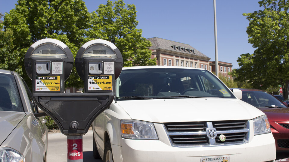 white car next to parking meters